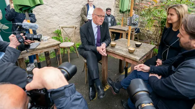 The press watch SNP leader John Swinney having coffee