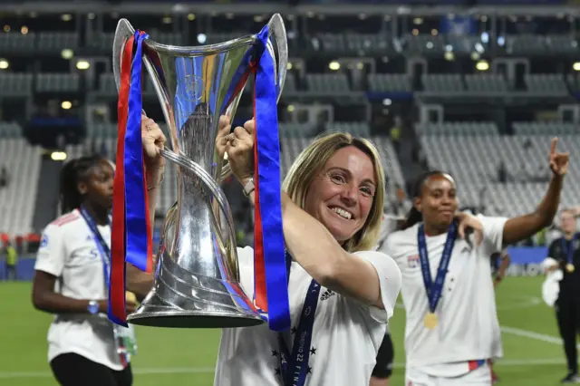 Sonia Bompastor, head coach of Olympique Lyonnais, lifts the Women Champions League trophy in 2022