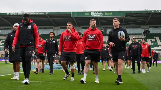 Saracens players walk out on the pitch at Franklin's Gardens before kick off