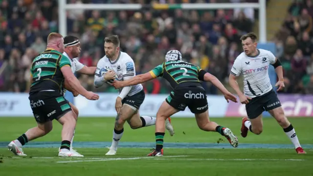 Elliot Daly runs into a tackle with the ball