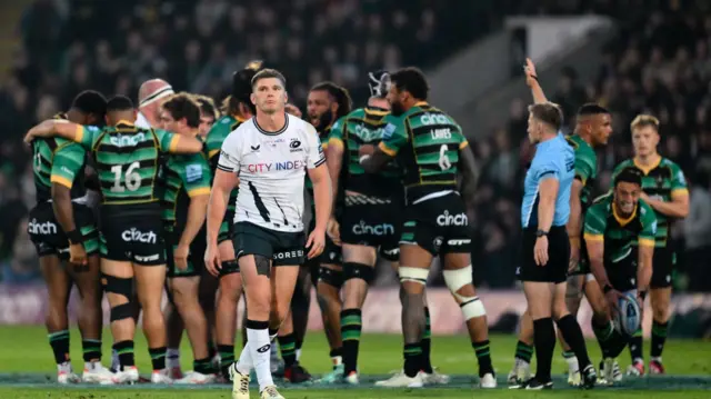 Owen Farrell walks away as Saints players celebrate