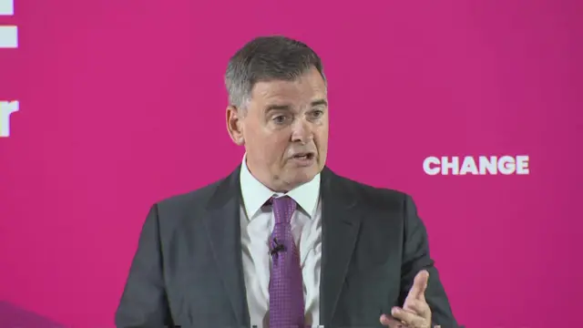 Mike Soutar in front of Labour's 'change' slogan