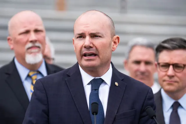 Mike Lee speaking at microphone