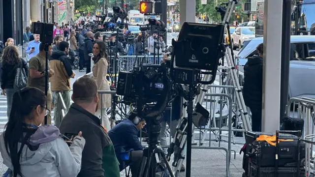 Crowds gather outside Trump Tower with camera crews and reporters bustling