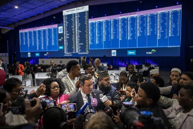 Leader of the Democratic Alliance (DA), South African main opposition party, John Steenhuisen (C) speaks with the media at the Independent Electoral Commission (IEC) National Results Center in Midrand on May 31, 2024