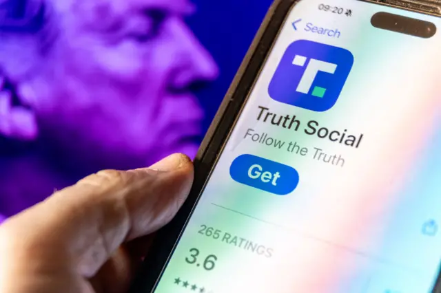 A smartphone screen displays the logo of Donald Trump's Truth Social app.