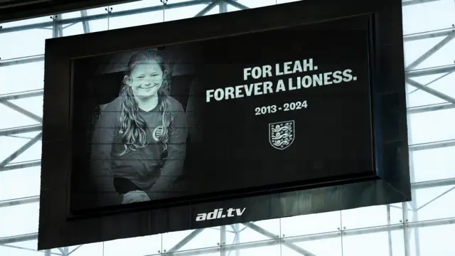 General view of the big screen as England fans applaud on the 10th minute in memory of 10 year old Leah Harrison