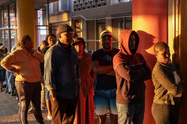 Voters wait in line outside the Yeoville Recreation Centre polling station in Johannesburg on 29 May.