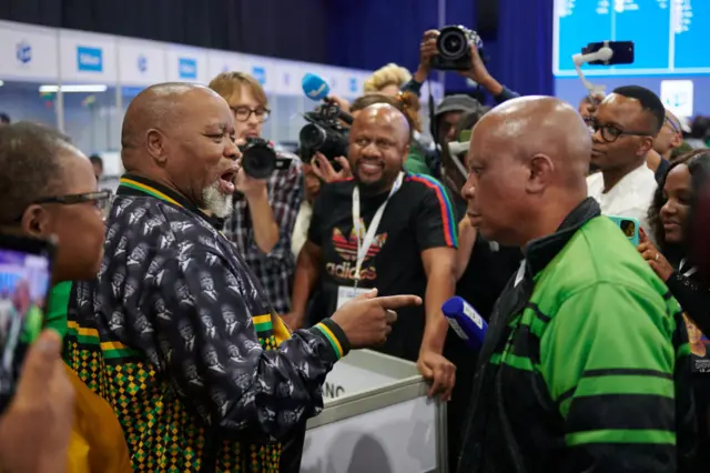 Gwede Mantashe, chairman of the African National Congress (ANC), left, speaks with Herman Mashaba, leader of ActionSA, right, at the Independent Electoral Commission (IEC) national results center in Midrand, South Africa, on Friday, May 31, 2024