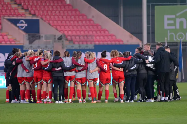 Wales players in a group huddle