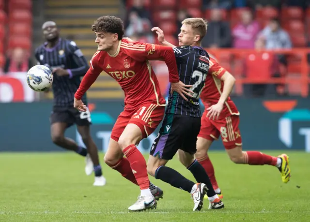 St Johnstone's Matthew Smith and Aberdeen's Dante Polvara in action during a cinch Premiership match between Aberdeen and St Johnstone