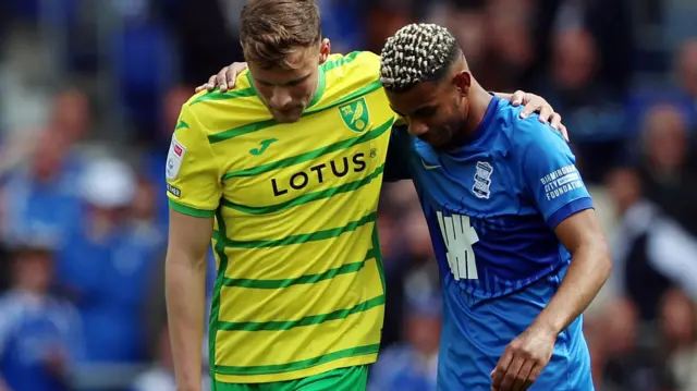 Norwich player hugs Birmingham player