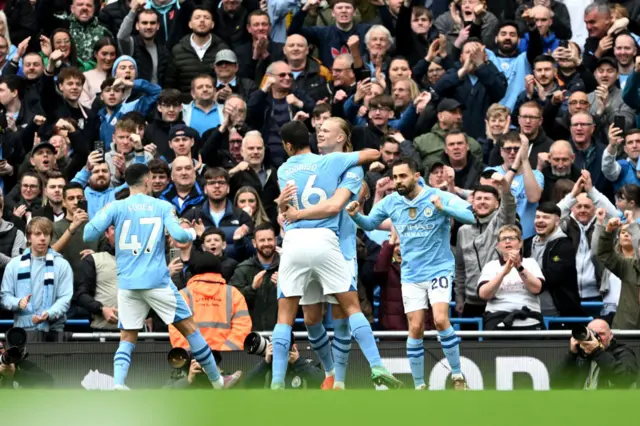 Erling Haaland of Manchester City celebrates scoring his team's first goal with teammates Rodri, Bernardo Silva and Phil Foden during the Premier League match between Manchester City and Wolverhampton Wanderers