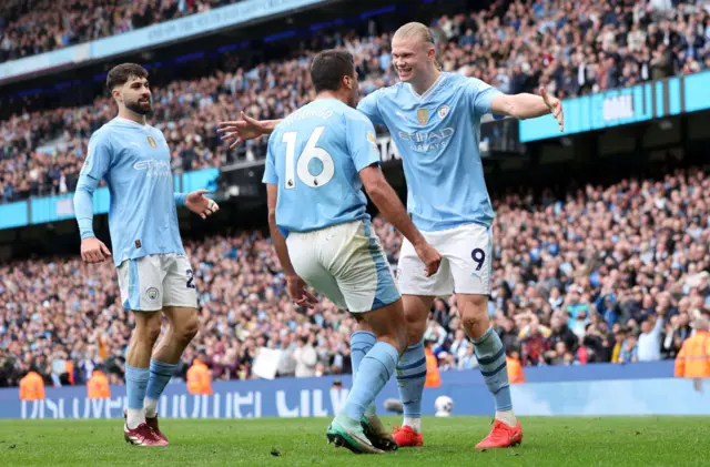 Erling Haaland of Manchester City celebrates scoring his team's second goal with teammate Rodri during the Premier League match between Manchester City and Wolverhampton Wanderers