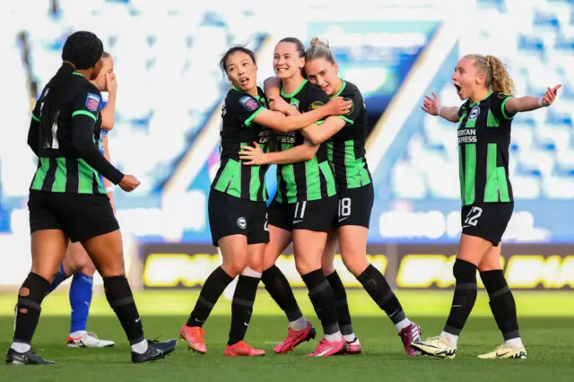 Brighton players flock Terland after her goal at Leicester