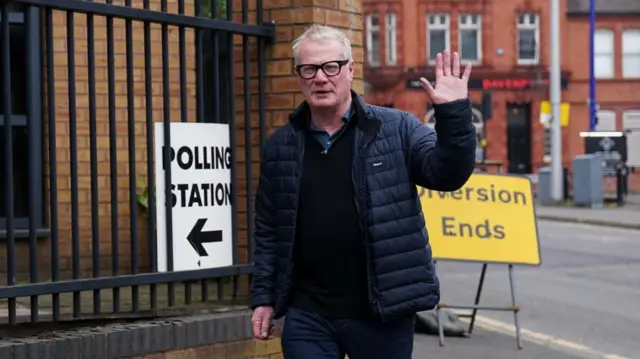 Richard Parker, Labour's mayoral candidate in the West Midlands, waves as he walks into a polling station