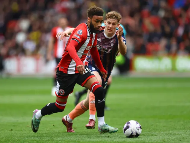 Sheffield United's Jayden Bogle in action with Nottingham Forest's Ryan Yates.