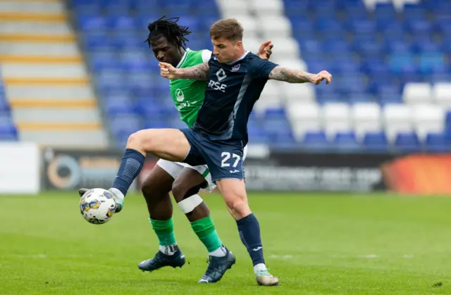 DINGWALL, SCOTLAND - MAY 04: Ross County's Eamonn Brophy (R) and Hibernian's Rocky Bushiri in action during a cinch Premiership match between Ross County and Hibernian at the Global Energy Stadium, on May 04, 2024, in Dingwall, Scotland. (Photo by Ross Parker / SNS Group)