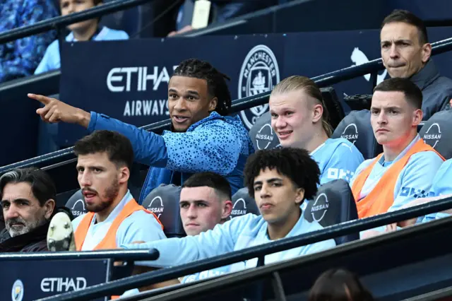 Erling Haaland of Manchester City looks on from the bench alongside teammates during the Premier League match between Manchester City and Wolverhampton Wanderers