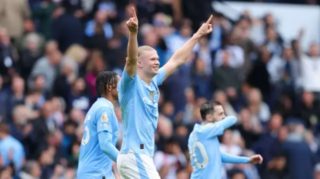 Erling Haaland of Manchester City celebrates after scoring his side's third goal from the penalty spot to complete his hat-trick during the Premier League match between Manchester City and Wolverhampton Wanderers