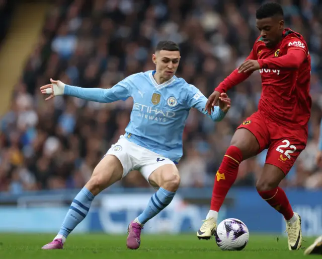 Phil Foden of Manchester City and Nelson Semedo of Wolverhampton Wanderers challenge during the Premier League match between Manchester City and Wolverhampton Wanderers