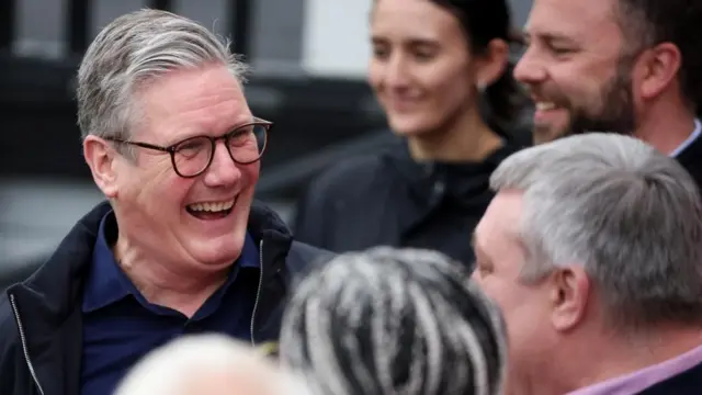 Keir Starmer smiles broadlt as he greets people in Blackpool