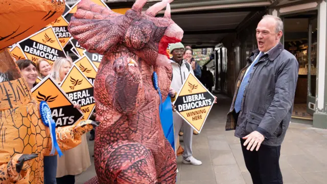 Liberal Democrat leader Sir Ed Davey greeted by Tory 'dinosaurs' at his party's celebration in Winchester