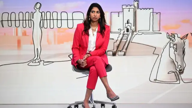 Suella Braverman sits in the studio