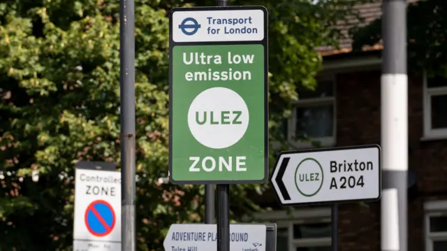 A street sign reads Ultra low emissions ULEZ zone