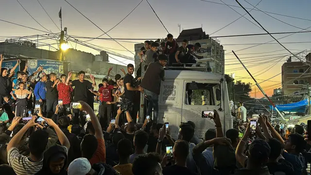 Crowds in Rafah celebrate reports that Hamas has agreed to ceasefire terms brokered by Egyptian and Qatari mediators