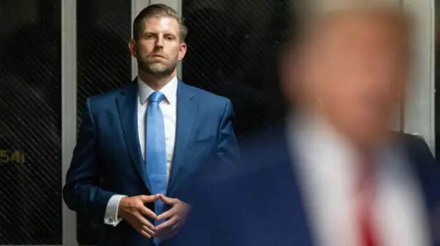 Eric Trump with his father in foreground