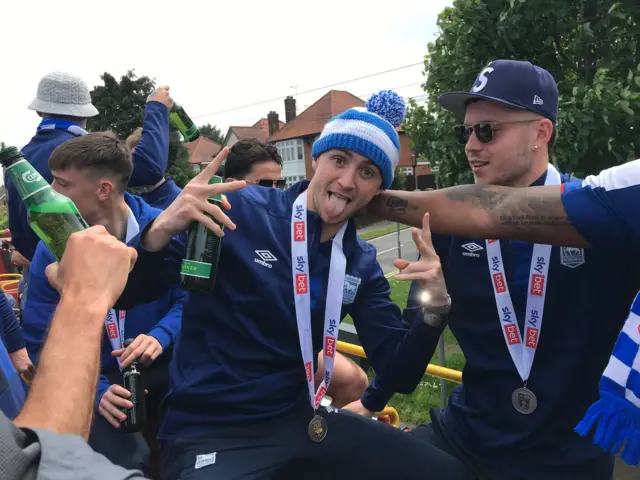 Jack Taylor and George Hirst celebrate on the Ipswich players' bus