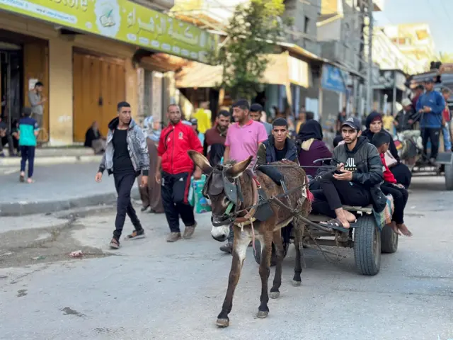 Palestinians flee the southern Gaza city of Rafah after warnings from Israeli forces that the city would be hit by attacks