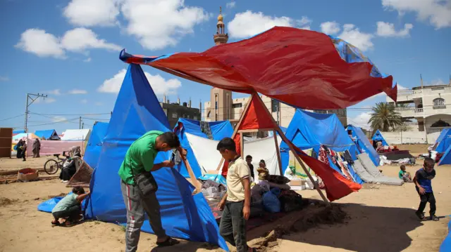 Man and child dismantling tent