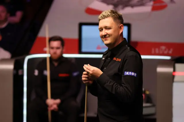 Kyren Wilson chalks his cue