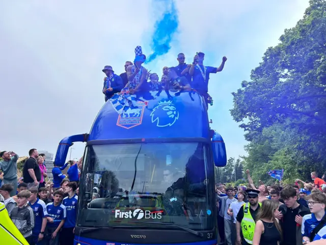 Ipswich players with a flare on the bus