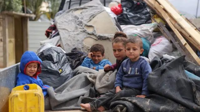 Children sitting in the back of a truck