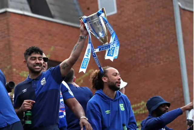 Massimo Luongo holding a trophy, with Marcus Harness