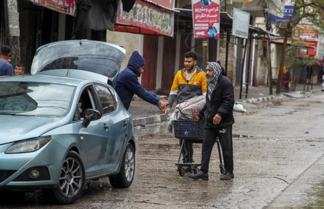 Palestinians are loading their stuff in a car, preparing to leave Rafah ahead of a planned Israeli military operation, 6 May 2024