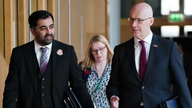 Humza Yousaf and John Swinney walk through Holyrood (file photo from 2022)