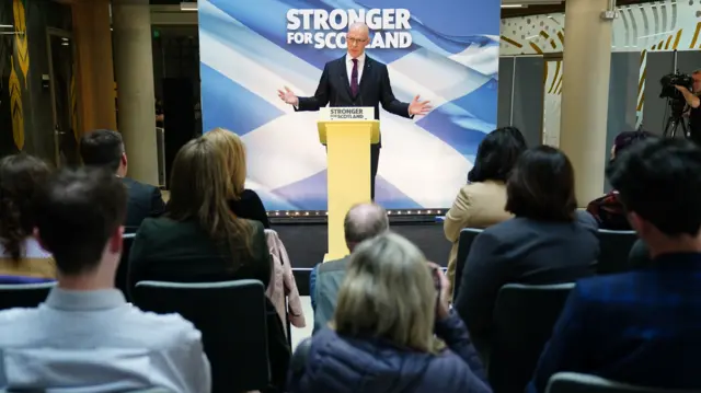 SNP leader John Swinney addresses colleagues and reporters