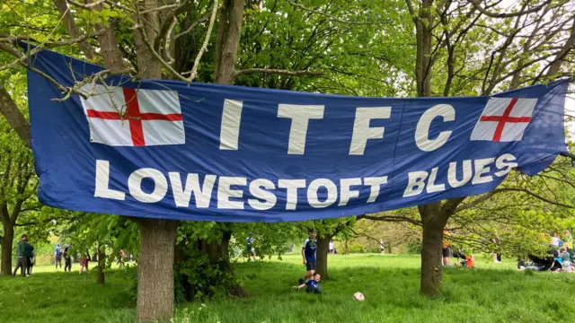 ITFC Lowestoft Blues flag hanging from trees outside Portman Road