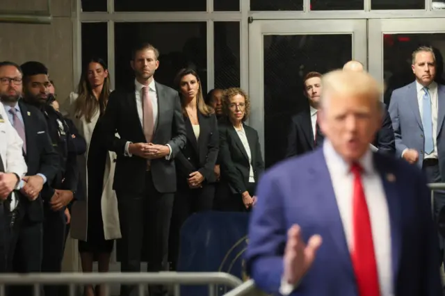 Eric Trump and Alina Habba watch Trump speak