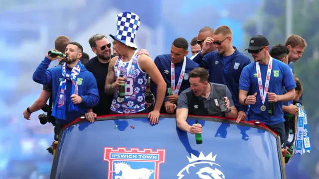 Ipswich Town players on the open-top bus during their promotion parade