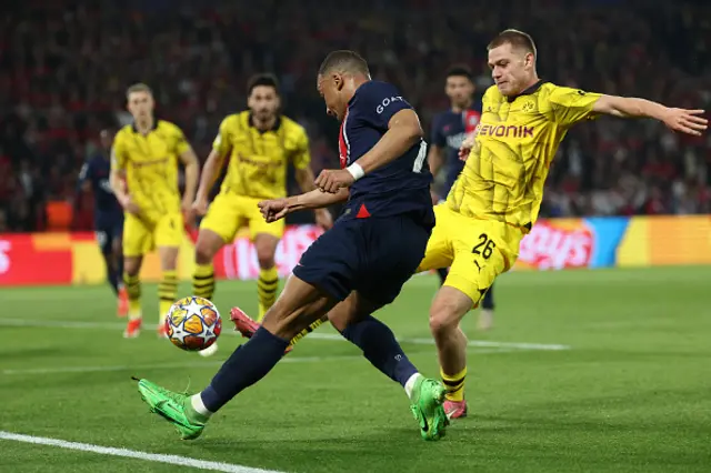 Kylian Mbappe and Julian Ryerson fight for the ball