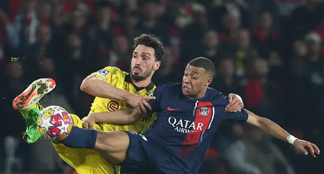 Kylian Mbappe (R) and Dortmund's German defender #15 Mats Hummels (L) fight for the ball