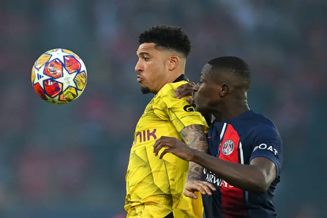 Jadon Sancho of Borussia Dortmund is challenged by Nuno Mendes