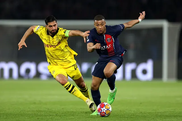 Kylian Mbappe of Paris Saint-Germain runs with the ball whilst under pressure from Emre Can