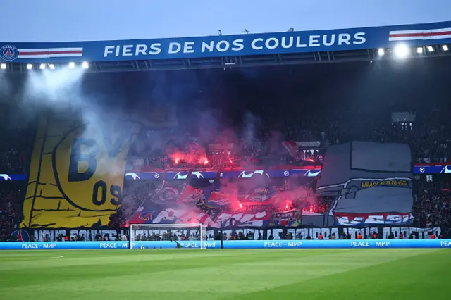 PSG supporters light flares in the stands