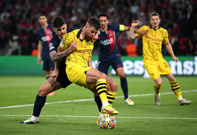 Niclas Fuellkrug of Borussia Dortmund controls the ball whilst under pressure from Lucas Beraldo